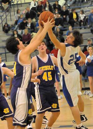 Bryant's Chase Christie (25) reaches for a rebound. (Photo by Kevin Nagle)