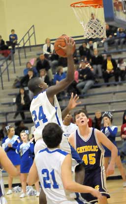 Bryant's Cedarrian Crosby (24) takes it to the rack in front of teammate Caleb Strain (21). (Photo by Kevin Nagle)