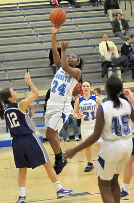 Dezerea Duckworth (24) drives to the hoop in front of teammates Jessica Alliston (21) and Kaitlyn Greer (45). (Photo by Kevin Nagle)