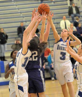 Bryant's Andrea Buford (12) and Keedy Harrison (3) fight for a rebound. (Photo by Kevin Nagle)