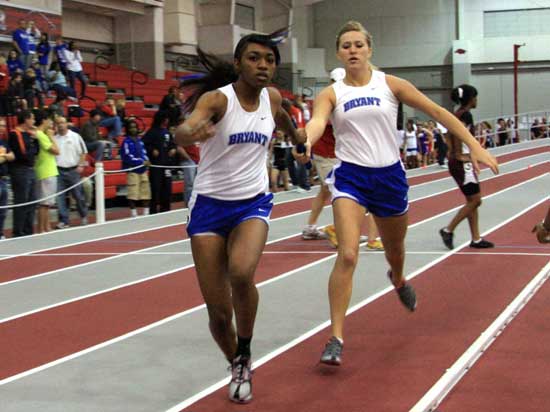 Brianna White takes the baton from teammate Bailee Seelinger in Saturday's 4x400 relay.