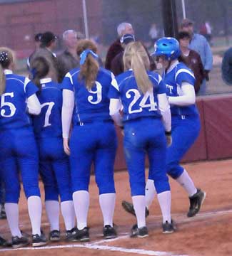 Jessie Taylor is greeted at home plate after smacking a grand slam on Monday. (Photo by Kevin Nagle)