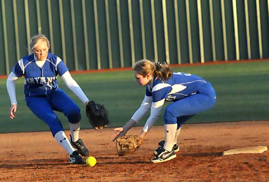 Cassidy Wilson, left, and Jenna Bruick converge on a grounder near second during Monday night's game against Benton. (Photo by Kevin Nagle)