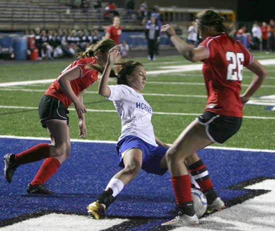 Bryant's Tarra Hendricks, middle, battles a pair of Searcy players for possession. (Photo by Rick Nation)