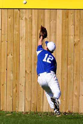 Bryant right fielder Evan Jobe races back for a deep fly. (Photo by Rick Nation)