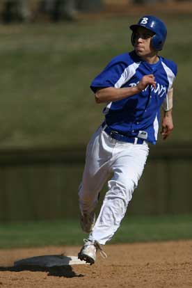 Josh Pultro rounds second and heads for third. (Photo by Rick Nation)