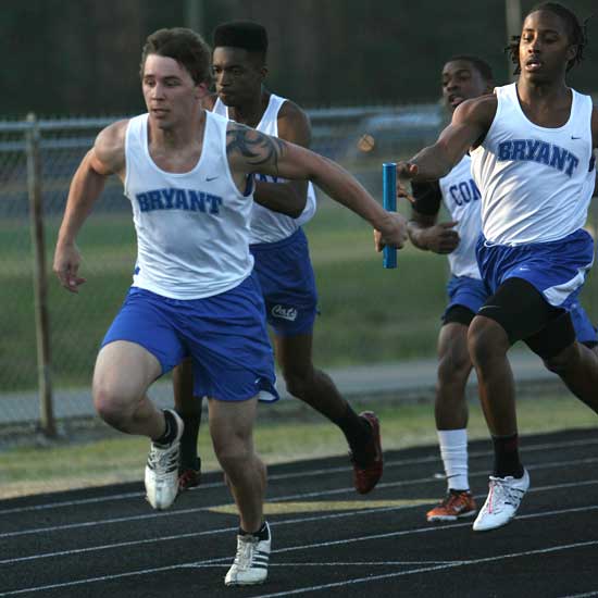 Bryant's Tanner Tolbert takes the baton from Dillon Winfrey during the Hornets' victory in the 4x100 relay Thursday. (Photo by Rick Nation)