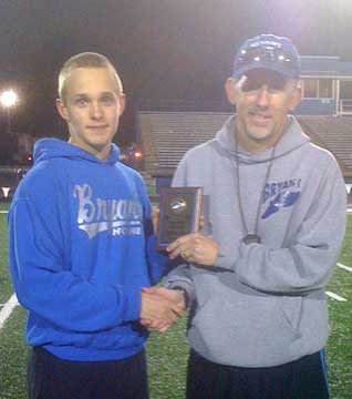 John Winn receives a plaque for being the individual point leader at Tuesday's Junior Hornet Relays. (Photo by Kevin Nagle)