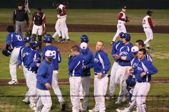 As Pine Bluff breaks up a meeting on the mound, Bryant does as well after a meeting along the first-base line Monday night. (Photo courtesy of Phil Pickett)