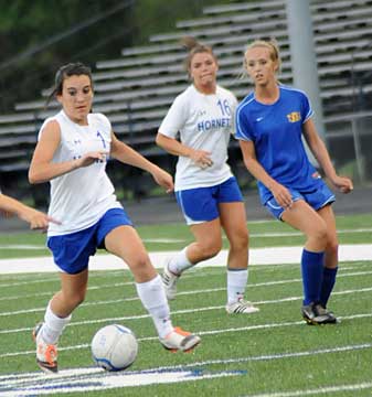 Lexie Balisterri maneuvers through the North Little Rock defense as Erica Selig trails the play. (Photo by Kevin Nagle)