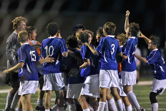 The Hornets celebrate after Bryce Denker's game-winning PK. (Photo by Rick Nation)