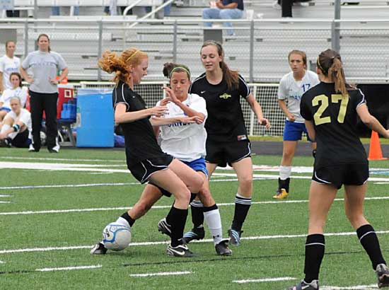 Bryant's Lexie Balisterri is sandwiched between a pair of Little Rock Central players during Monday night's game as head coach Julie Long, left, looks on from the sideline. (Photo by Kevin Nagle)