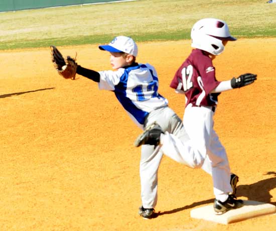 Carson Nagle, left, stretches to haul in a throw at first. (Photo by Kevin Nagle)