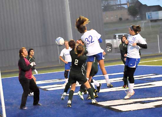 Rori Whittaker (32) and Erica Selig (16) battle with Van Buren players in front of the goal. (Photo by Kevin Nagle)