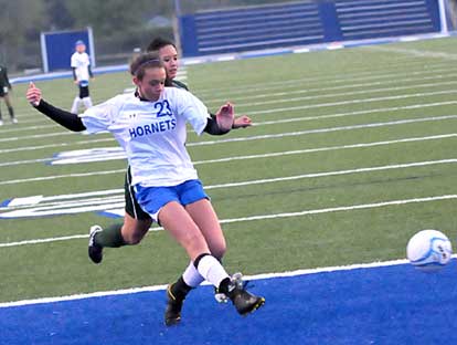 Bryant's McKenzie Adams (23) gets a shot away in front of a Van Buren defender. (Photo by Kevin Nagle)