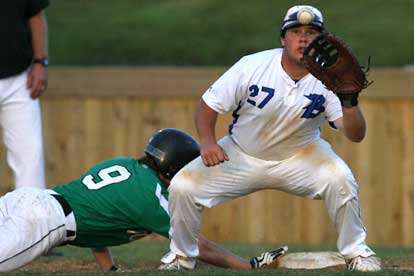 First baseman Landon Pickett takes a pickoff throw to first as Van Buren's Jake Smith dives back to the bag. (Photo by Rick Nation)