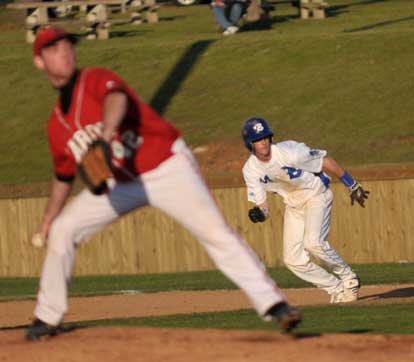 Jordan Taylor breaks from first as Cabot's Cole Nicholson, foreground, delivers a pitch. (Photo by Kevin Nagle)