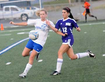 Lyndsey Brazil (22) fends off a Mount St. Mary player. (Photo by Kevin Nagle)