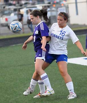 Erica Selig, right, tries to wedge her way past a Mount St. Mary player. (Photo by Kevin Nagle)