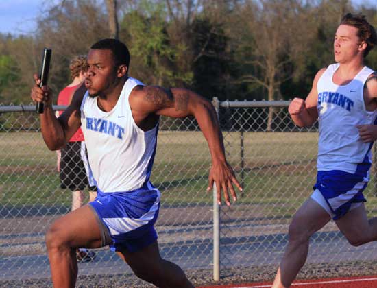 Bryant's Stephen Clark, left, takes off after getting the baton from teammate Tanner Tolbert. (Photo courtesy of Carla Thomas)