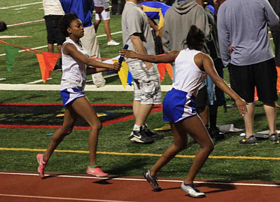 Candice Ball hands the baton to Kiana Thomas during the 1600 meter relay Friday. (Photo courtesy of Carla Thomas)