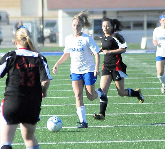 Bryant's Katie Moore weaves through the Russellville team. (Photo by Kevin Nagle)