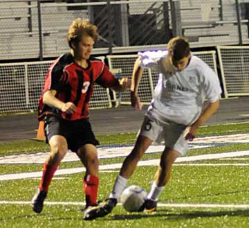 Ryan Watson, right, battles a Russellville player. (Photo by Kevin Nagle)