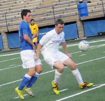 Holden Chavis, right, fends off a Conway player. (Photo by Kevin Nagle)