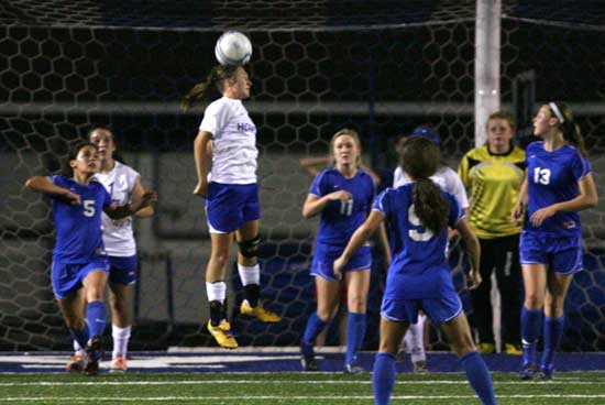 Bryant's Tarra Hendricks heads the ball out from in front of the Bryant goal to thwart a Conway attack. (Photo by Rick Nation)