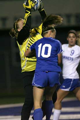 Bryant keeper Kaitlin Miller saves a goal under duress from a Conway player. (Photo by Rick Nation)