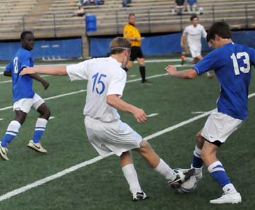 Kyle Nossaman (15) and a Conway player contend for control of the ball. (Photo by Kevin Nagle)