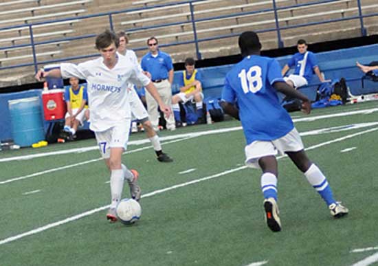 Bryant's Justin Travis, left, tries to maneuver around a Conway player. (Photo by Kevin Nagle)