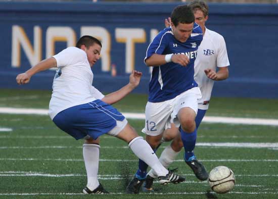 Bryce Denker (12) splits a pair of North Little Rock defenders. (Photo by Rick Nation)