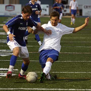 Bryant's Ben Stukenborg (8) battles a North Little Rock player for possession. (Photo by Rick Nation)