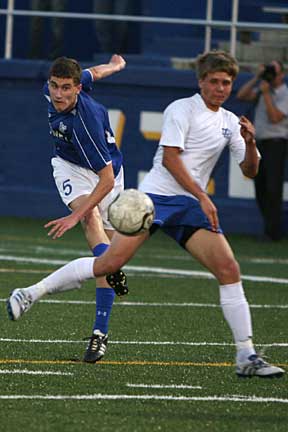 Ryan Watson, left, rips a kick past a North Little Rock player. (Photo by Rick Nation)