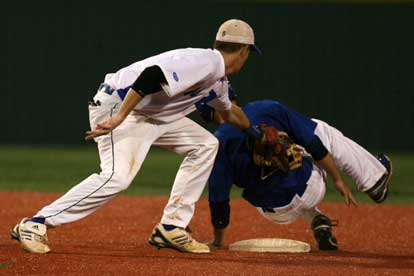 Bryant shortstop Jordan Taylor tags a Conway base runner after he slides past the bag at second. (Photo by Rick Nation)