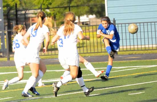Bryant's Rori Whittaker (32) clears the ball as a group of Conway players converge. (Photo by Kevin Nagle)