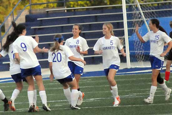 The Lady Hornets celebrate a goal during Thursday's game. (Photo by Kevin Nagle)