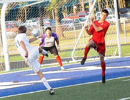 Jesse Wolf, left, sends a shot goal-ward. (Photo by Kevin Nagle)