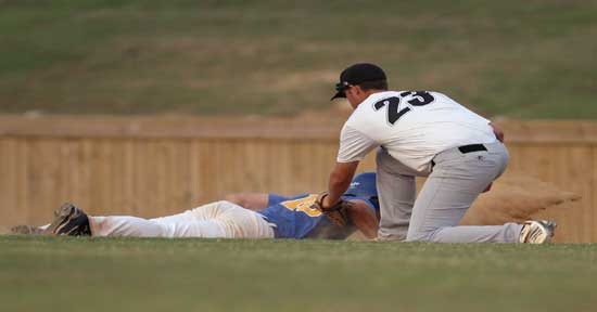 Bryant first baseman Tryce Schalchlin applies a tag on a pickoff play at first. (Photo by Rick Nation)