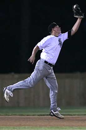 Bryant third baseman Tyler Brown reaches high to snare a line drive. (Photo by Rick Nation)