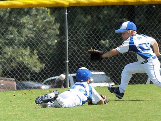 Matthew Griffe and Grant Johnson chase a gapper during Sunday's game. (Photo by Kevin Nagle)