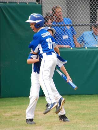 Logan Chambers celebrates after scoring the tying run in the sixth.