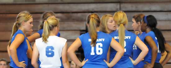 Bryant head coach Beth Solomon huddles with her team during a timeout. (Photo by Kevin Nagle)
