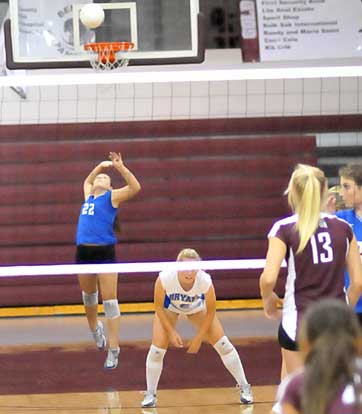 Taylor West (22) serves as teammate Lauren Reed (6) sets up for a return. (Photo by Kevin Nagle)