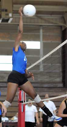 Brianna White goes high for a hit. (Photo by Kevin Nagle)