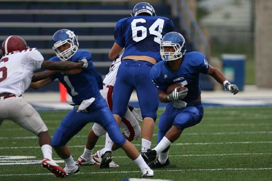 Karon Dismuke (5) cuts behind blocks from teammates Sawyer Nichols (1) and Seth Alkire (64) on the way to a 36-yard run. (Photo by Rick Nation)