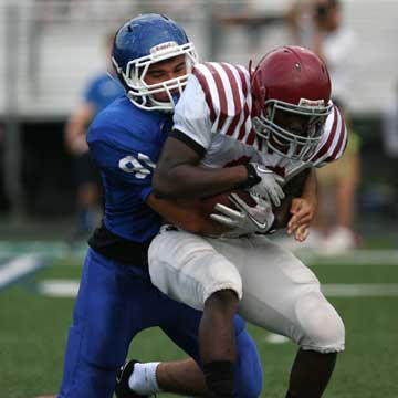 Tim Kelly (91) puts the wraps on Pine Bluff running back Jalen Dabner. (Photo by Rick Nation)