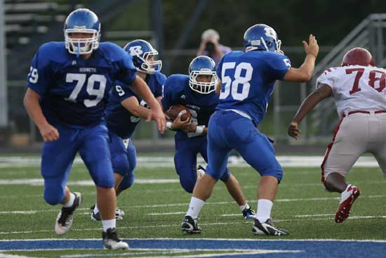 Caleb Thomas takes a handoff from Wesley Akers and looks to take advantage of blocks by Jordan Jones (79) and Brandon Caple (58). (Photo by Rick Nation)