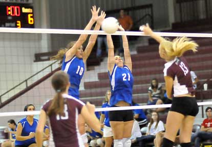 Alyssa Anderson (10) and Courtney Davidson (21) go up for a block. (Photo by Kevin Nagle)